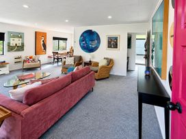 A living room with a sofa and table at Gallery Grove - New Plymouth Holiday Home in New Plymouth