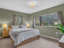 A bedroom with a bed and a window at Surf House - Mangawhai Heads Holiday Home Mangawhai Heads