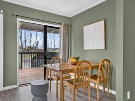 A dining area with a table and chairs at Surf House - Mangawhai Heads Holiday Home Mangawhai Heads