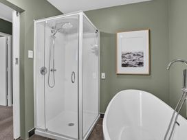 A bathroom with a shower and bathtub at Surf House - Mangawhai Heads Holiday Home Mangawhai Heads