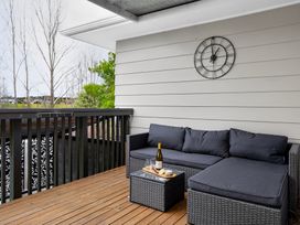 An outdoor area with a sofa and coffee table at Surf House - Mangawhai Heads Holiday Home Mangawhai Heads