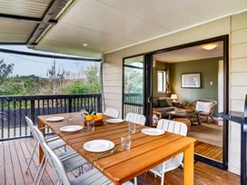 A dining area with a table set for dinner at Surf House - Mangawhai Heads Holiday Home, Mangawhai Heads