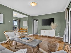 A living room with a TV and coffee table at Surf House - Mangawhai Heads Holiday Home Mangawhai Heads