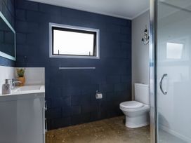 A bathroom with a sink and toilet at Natives Nest - Karikari Peninsula