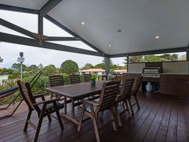 An outdoor patio with a table and chairs at Natives Nest - Karikari Peninsula