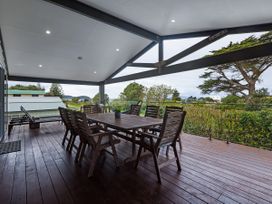 An outdoor dining area with a table and chairs at Natives Nest - Karikari Peninsula
