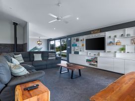 A living room with a sofa and coffee table at Natives Nest - Karikari Peninsula