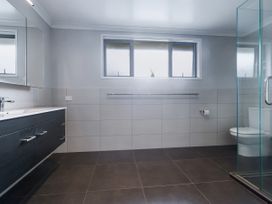 A bathroom with a wash basin and shower at Natives Nest - Karikari Peninsula