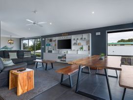 A living room with a couch and coffee table at Natives Nest - Karikari Peninsula
