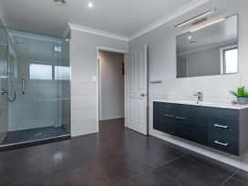 A bathroom with a shower and vanity at Natives Nest - Karikari Peninsula