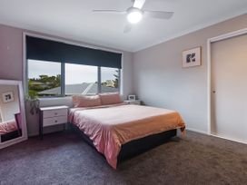 A bedroom with a bed and bedside table at Natives Nest - Karikari Peninsula