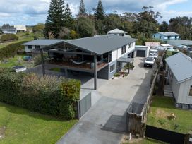 An outdoor view of a house with a driveway and trees at Natives Nest - Karikari Peninsula