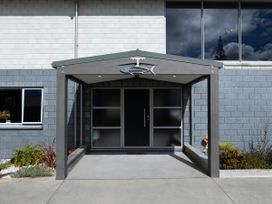 An entrance with a door and fish sculpture at Natives Nest - Karikari Peninsula Holiday Home Karikari Peninsula