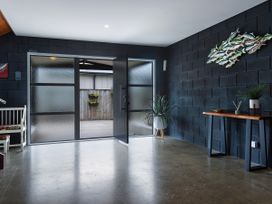 A hallway with double doors leading outside at Natives Nest - Karikari Peninsula Holiday Home, Karikari Peninsula