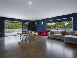 A living room with a table and seating at Natives Nest - Karikari Peninsula