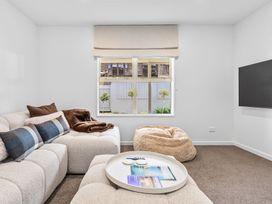 A living room with a sofa and TV at Helmstead Cottage - Arrowtown