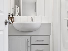 A sink with soap dispensers and drawers at Helmstead Cottage - Arrowtown