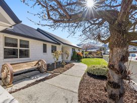 An outdoor view with a pathway and garden at Helmstead Cottage - Arrowtown