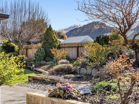 A garden with flowers and shrubs at Helmstead Cottage - Arrowtown