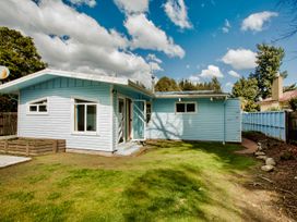 A blue house with garden and satellite dish at Little Blue House - Te Anau