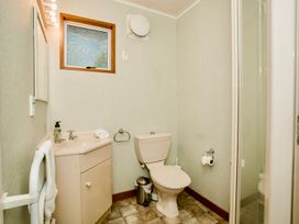 A bathroom with a toilet and sink at Little Blue House - Te Anau