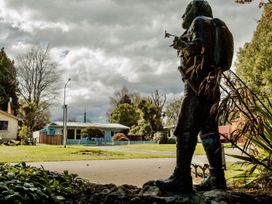 A statue in front of a house at Little Blue House - Te Anau