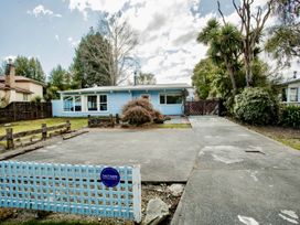 A house with a fence and driveway at Little Blue House - Te Anau