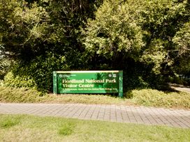 A sign for Fiordland National Park Visitor Centre in Te Anau