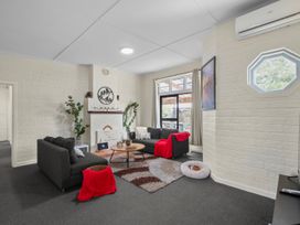 A living room with a sofa and fireplace at Cozy Family Home - Manukau City Holiday Home, Manukau City