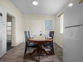 A dining room with a table and chairs at Cozy Family Home - Manukau City