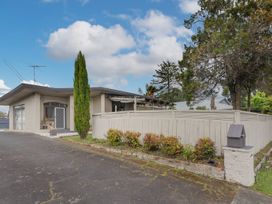 A house with a fence and greenery at Cozy Family Home - Manukau City
