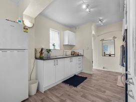 A kitchen with refrigerator sink and cabinets at Cozy Family Home - Manukau City Holiday Home Manukau City