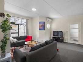 A living room with sofas and a television at Cozy Family Home - Manukau City Holiday Home Manukau City