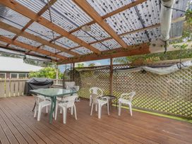 A patio with a table and chairs at Cozy Family Home - Manukau City