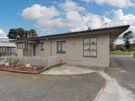 A house with a fence and garden at Cozy Family Home - Manukau City