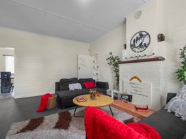 A living room with a sofa and coffee table at Cozy Family Home - Manukau City Holiday Home Manukau City