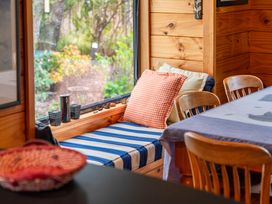 A dining room with a seating area and window view at Lakeside on Te Waaka - Kuratau Holiday Home, Kuratau