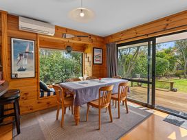 A dining room with a table and chairs at Lakeside on Te Waaka - Kuratau
