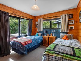 A bedroom with two beds and a window at Lakeside on Te Waaka - Kuratau