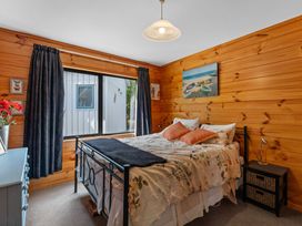 A bedroom with a bed and window at Lakeside on Te Waaka - Kuratau