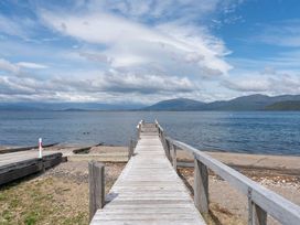 A dock extending into the water at Lakeside on Te Waaka - Kuratau Holiday Home Kuratau