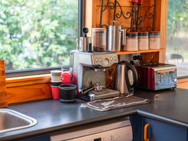 A kitchen with an espresso machine and kettle at Lakeside on Te Waaka - Kuratau