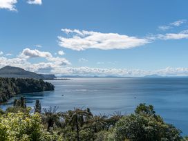 A lake view with mountains and cloudy sky at Fern View - Pukawa Bay Holiday Home Pukawa Bay