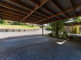 A carport with a paved surface and a curved driveway at Fern View - Pukawa Bay Holiday Home Pukawa Bay