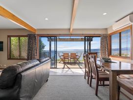 A living room with a dining area and view at Fern View - Pukawa Bay Holiday Home Pukawa Bay