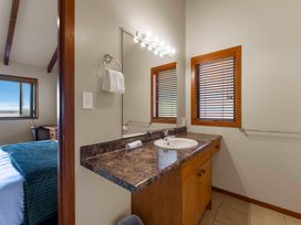 A bathroom with a sink and mirror at Fern View - Pukawa Bay Holiday Home Pukawa Bay