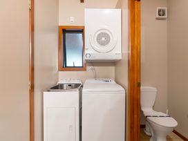 A laundry room with a washing machine and dryer at Fern View - Pukawa Bay
