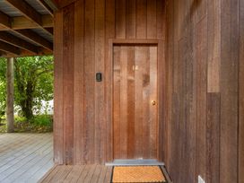 An entrance with a wooden door and a doormat at Fern View - Pukawa Bay Holiday Home Pukawa Bay