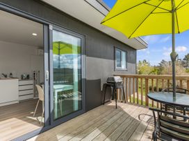 An outdoor area with a table and chairs at Over the Paddock - Waipu