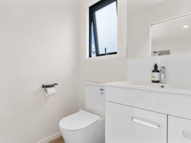 A bathroom with a sink and toilet at Over the Paddock - Waipu